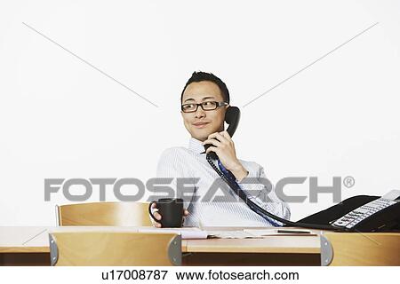 Stock Photo - Close-up of a businessman talking on the telephone. Fotosearch