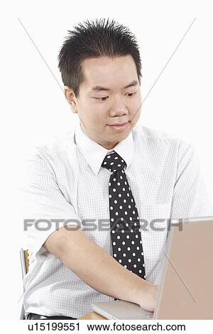 Stock Image - Close-up of a businessman using a laptop. Fotosearch