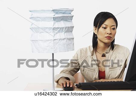 Stock Image - Close-up of a businesswoman using a computer. Fotosearch