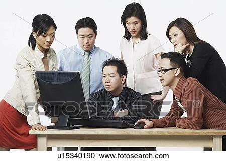 Group of business executives looking at a computer View Large Photo Image Stock Image - Group of business executives looking at a computer. Fotosearch