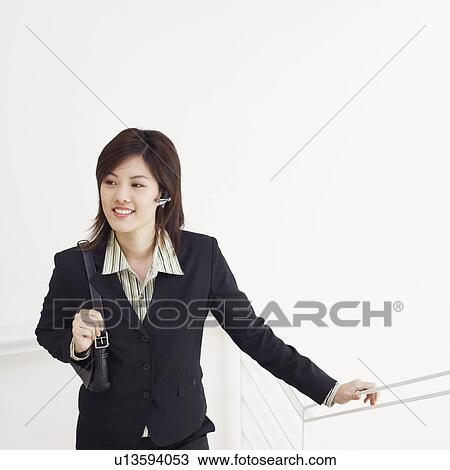 High angle view of a businesswoman walking up a staircase and smiling View Large Photo Image Stock Image - High angle view of a businesswoman walking up a staircase and smiling. Fotosearch
