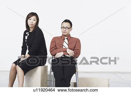 Portrait of a businessman and a businesswoman sitting View Large Photo Image Picture - Portrait of a businessman and a businesswoman sitting. Fotosearch