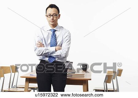 Portrait of a businessman looking serious View Large Photo Image Stock Image - Portrait of a businessman looking serious. Fotosearch