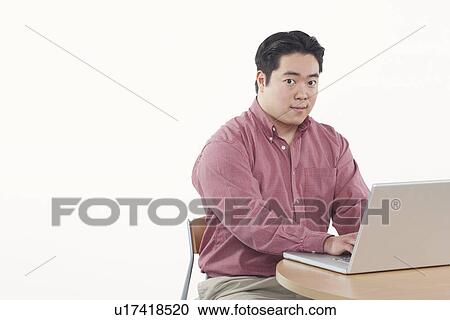 Portrait of a businessman using a laptop View Large Photo Image Stock Image - Portrait of a businessman using a laptop. Fotosearch