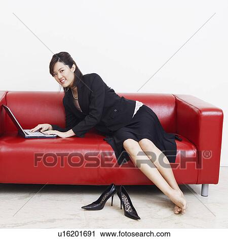 Portrait of a businesswoman using a laptop and smiling View Large Photo Image Stock Image - Portrait of a businesswoman using a laptop and smiling. Fotosearch