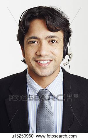 Stock Image - Portrait of a male customer service representative smiling. Fotosearch
