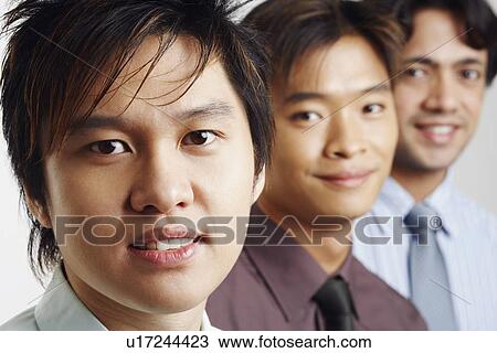 Stock Image - Portrait of three businessmen smiling. Fotosearch