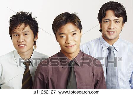 Stock Photo - Portrait of three businessmen smiling. Fotosearch