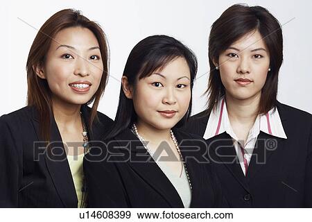 Stock Photo - Portrait of three businesswomen smiling. Fotosearch