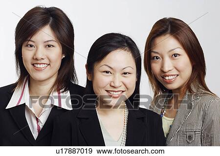 Stock Photo - Portrait of three businesswomen smiling. Fotosearch