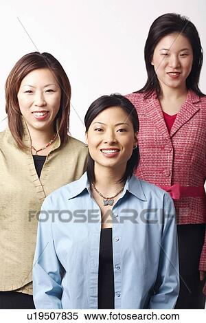 Stock Photography - Portrait of three businesswomen smiling. Fotosearch