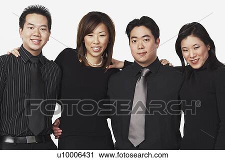 Stock Image - Portrait of two businessmen and two businesswomen smiling. Fotosearch