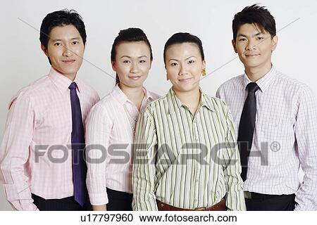 Portrait of two businesswomen and two businessmen smiling View Large Photo Image Stock Image - Portrait of two businesswomen and two businessmen smiling. Fotosearch