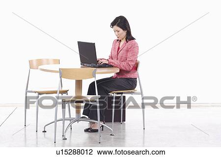 Side profile of a businesswoman using a laptop View Large Photo Image Stock Image - Side profile of a businesswoman using a laptop. Fotosearch