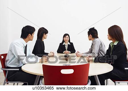Business executives sitting in a board room View Large Photo Image Stock Photography - Business executives sitting in a board room. Fotosearch