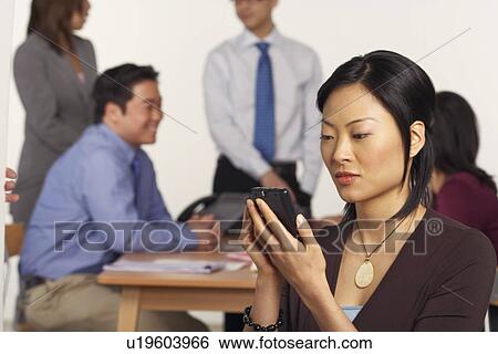 Businesswoman holding a personal data assistant View Large Photo Image Stock Photograph - Businesswoman holding a personal data assistant. Fotosearch