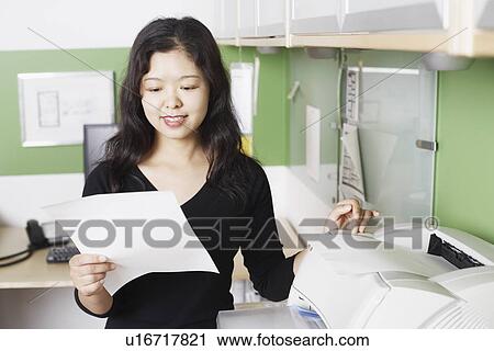 Businesswoman holding a printout smiling View Large Photo Image Stock Image - Businesswoman holding a printout smiling. Fotosearch