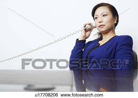 Businesswoman talking on the telephone View Large Photo Image Stock Photograph - Businesswoman talking on the telephone. Fotosearch