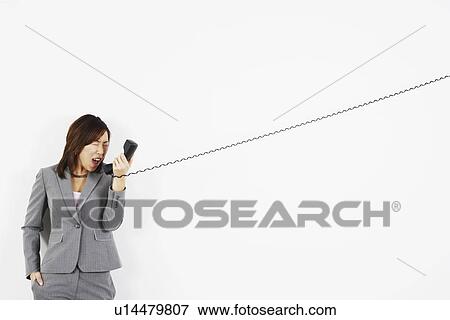Businesswoman yelling on the telephone View Large Photo Image Stock Photo - Businesswoman yelling on the telephone. Fotosearch