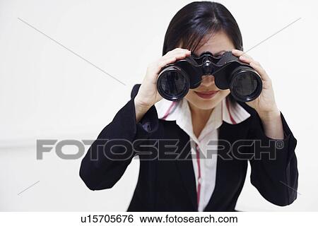 Close-up of a businesswoman looking through a pair of binoculars View Large Photo Image Stock Photograph - Close-up of a businesswoman looking through a pair of binoculars. Fotosearch