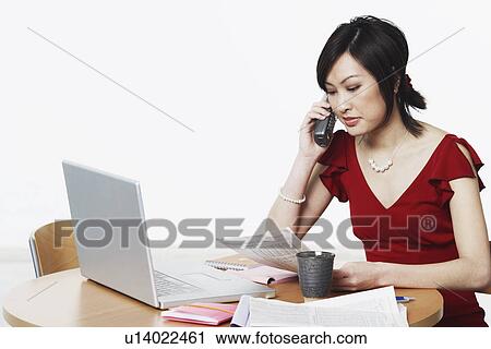 Close-up of a businesswoman talking on the telephone View Large Photo Image Stock Image - Close-up of a businesswoman talking on the telephone. Fotosearch