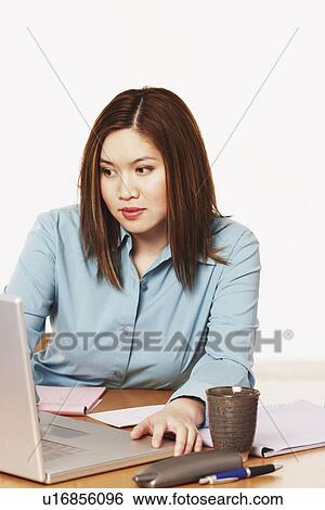 Stock Photograph - Close-up of a businesswoman using a laptop. Fotosearch
