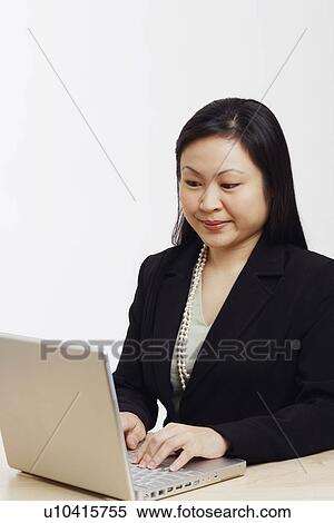 Stock Photography - Close-up of a businesswoman using a laptop. Fotosearch