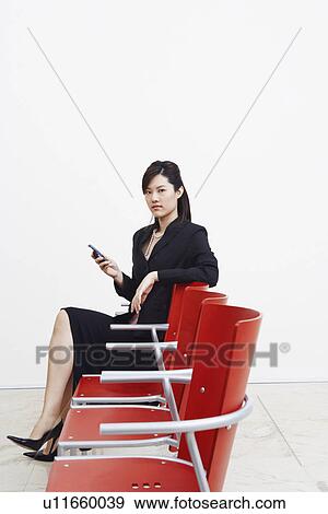 Portrait of a businesswoman holding a mobile phone View Large Photo Image Stock Photo - Portrait of a businesswoman holding a mobile phone. Fotosearch