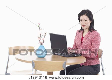 Portrait of a businesswoman using a laptop View Large Photo Image Stock Photograph - Portrait of a businesswoman using a laptop. Fotosearch