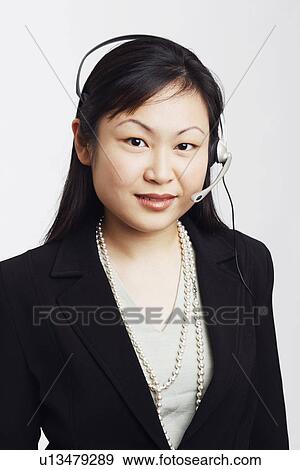 Stock Photo - Portrait of a businesswoman wearing a headset. Fotosearch