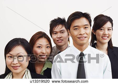 Stock Image - Portrait of three businesswomen and two businessmen smiling. Fotosearch