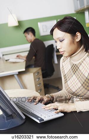 Side profile of a businesswoman using a computer View Large Photo Image Stock Image - Side profile of a businesswoman using a computer. Fotosearch