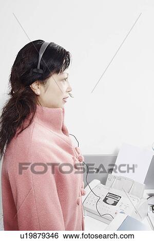 Stock Photograph - Side profile of a mature woman wearing a headset. Fotosearch