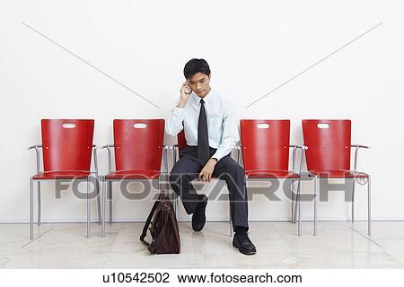 Businessman talking on a mobile phone View Large Photo Image Stock Image - Businessman talking on a mobile phone. Fotosearch