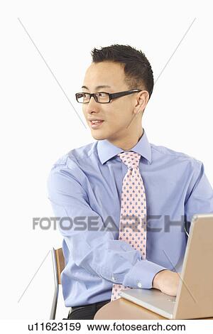 Close-up of a businessman using a laptop View Large Photo Image Stock Photo - Close-up of a businessman using a laptop. Fotosearch