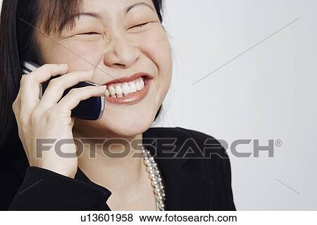 Close-up of a businesswoman talking on a mobile phone View Large Photo Image Stock Photo - Close-up of a businesswoman talking on a mobile phone. Fotosearch