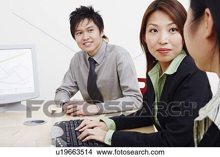 Close-up of business executives looking at each other and smiling View Large Photo Image Picture - Close-up of business executives looking at each other and smiling. Fotosearch