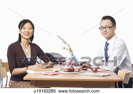 Portrait of a businessman and a businesswoman smiling View Large Photo Image Stock Photography - Portrait of a businessman and a businesswoman smiling. Fotosearch