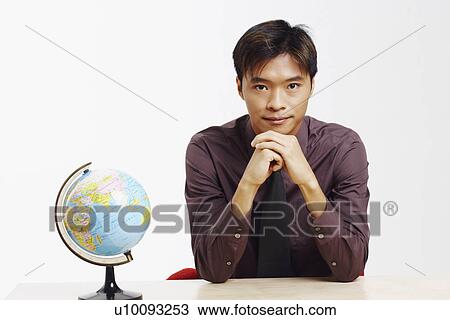 Stock Image - Portrait of a businessman thinking. Fotosearch
