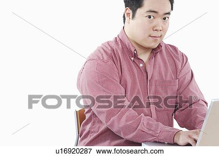 Portrait of a businessman using a laptop View Large Photo Image Stock Photo - Portrait of a businessman using a laptop. Fotosearch