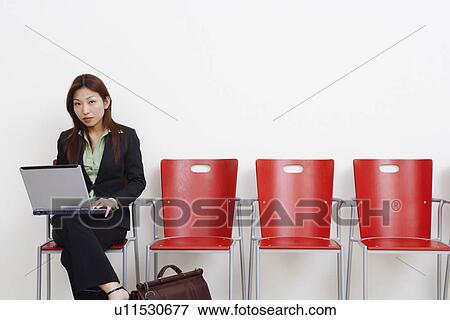 Stock Photo - Portrait of a businesswoman using a laptop. Fotosearch