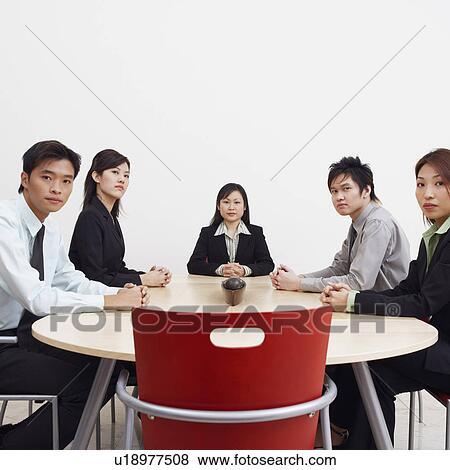 Portrait of business executives sitting in a board room View Large Photo Image Stock Photo - Portrait of business executives sitting in a board room. Fotosearch