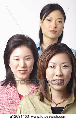 Portrait of three businesswomen smiling View Large Photo Image Stock Image - Portrait of three businesswomen smiling. Fotosearch