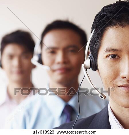 Stock Image - Portrait of three male customer service representatives. Fotosearch