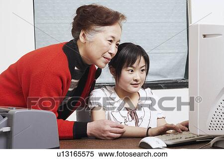 Close-up of a grandmother standing beside her granddaughter View Large Photo Image Stock Photography - Close-up of a grandmother standing beside her granddaughter. Fotosearch