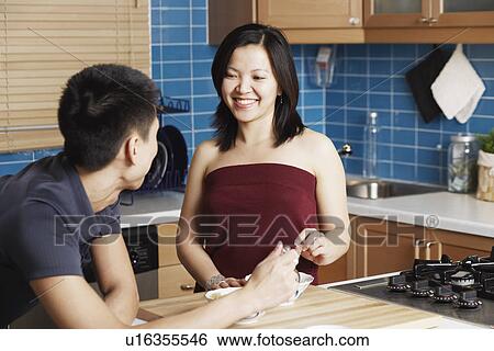 Close-up of a young couple in the kitchen View Large Photo Image Stock Photograph - Close-up of a young couple in the kitchen. Fotosearch