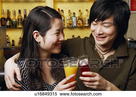Close-up of a young couple smiling View Large Photo Image Stock Photography - Close-up of a young couple smiling. Fotosearch