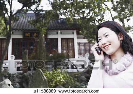 Stock Photo - Close-up of a young woman talking on a mobile phone. Fotosearch