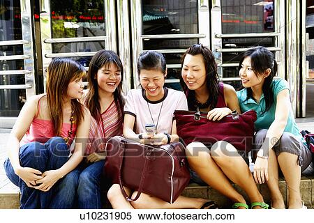 Five young women sitting together and smiling View Large Photo Image Stock Photography - Five young women sitting together and smiling. Fotosearch