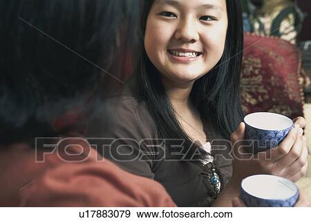 Stock Photo - Close-up of a girl holding a tea cup. Fotosearch